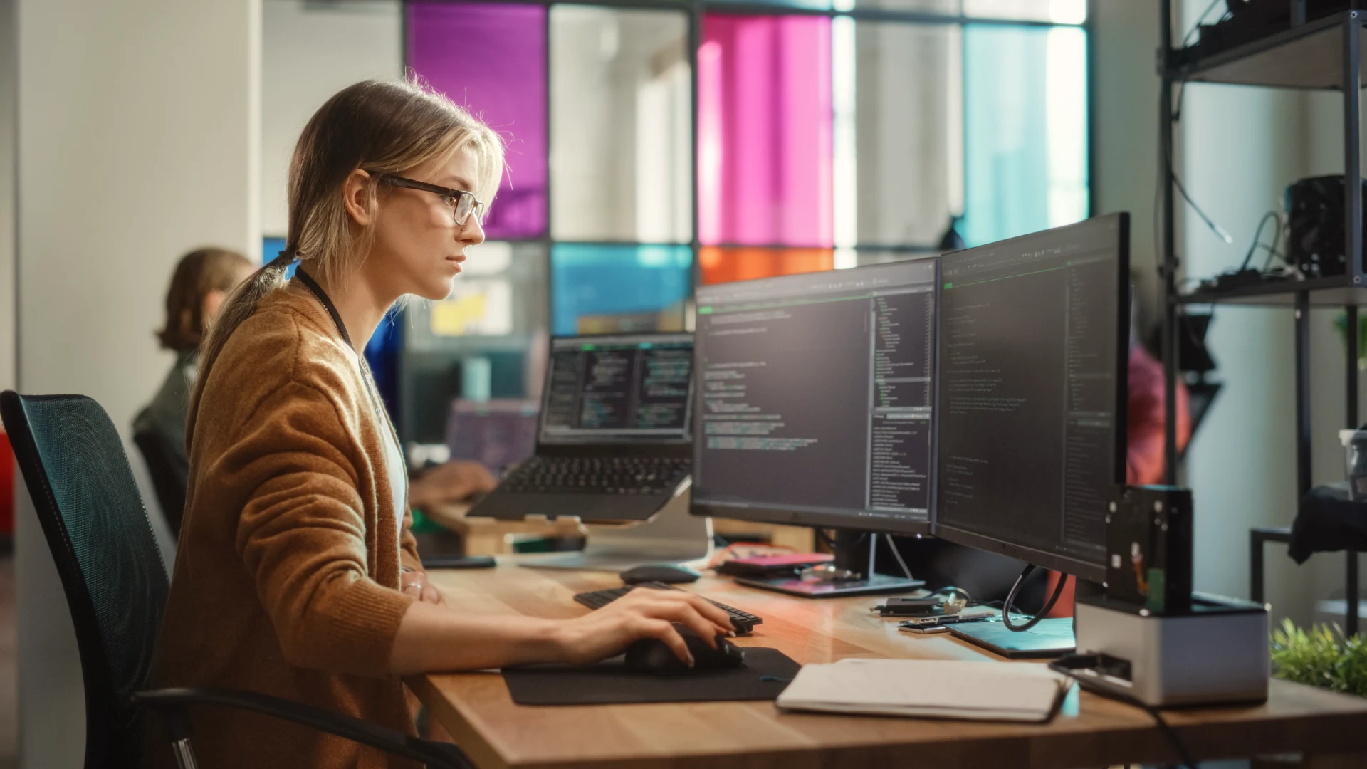 Professional web developer coding custom website in modern office